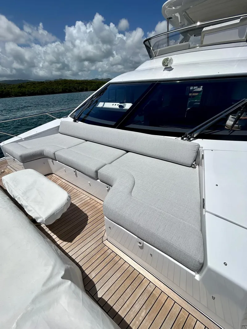 Slide: The Image of 2023 Azimut Fly 60 yacht with spacious deck seating under a cloudy sky. - 26