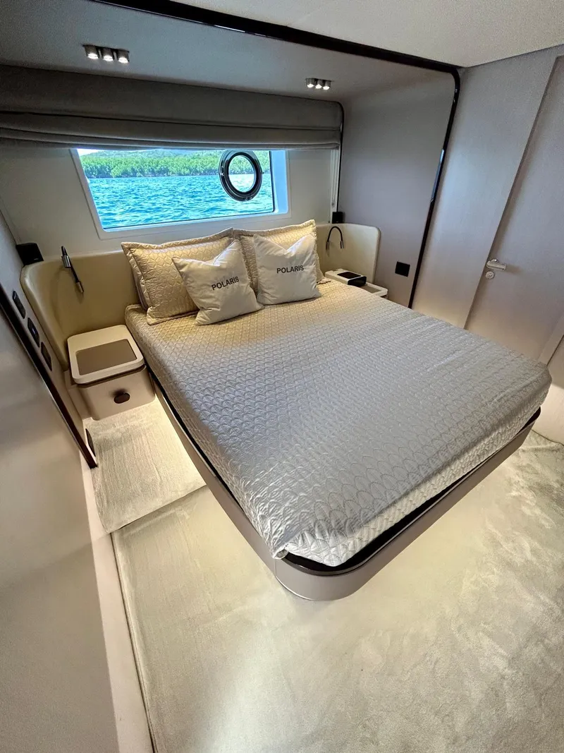Slide: The Image of Luxurious bedroom interior of 2023 Azimut Fly 60 yacht with elegant bedding and scenic window view. - 3