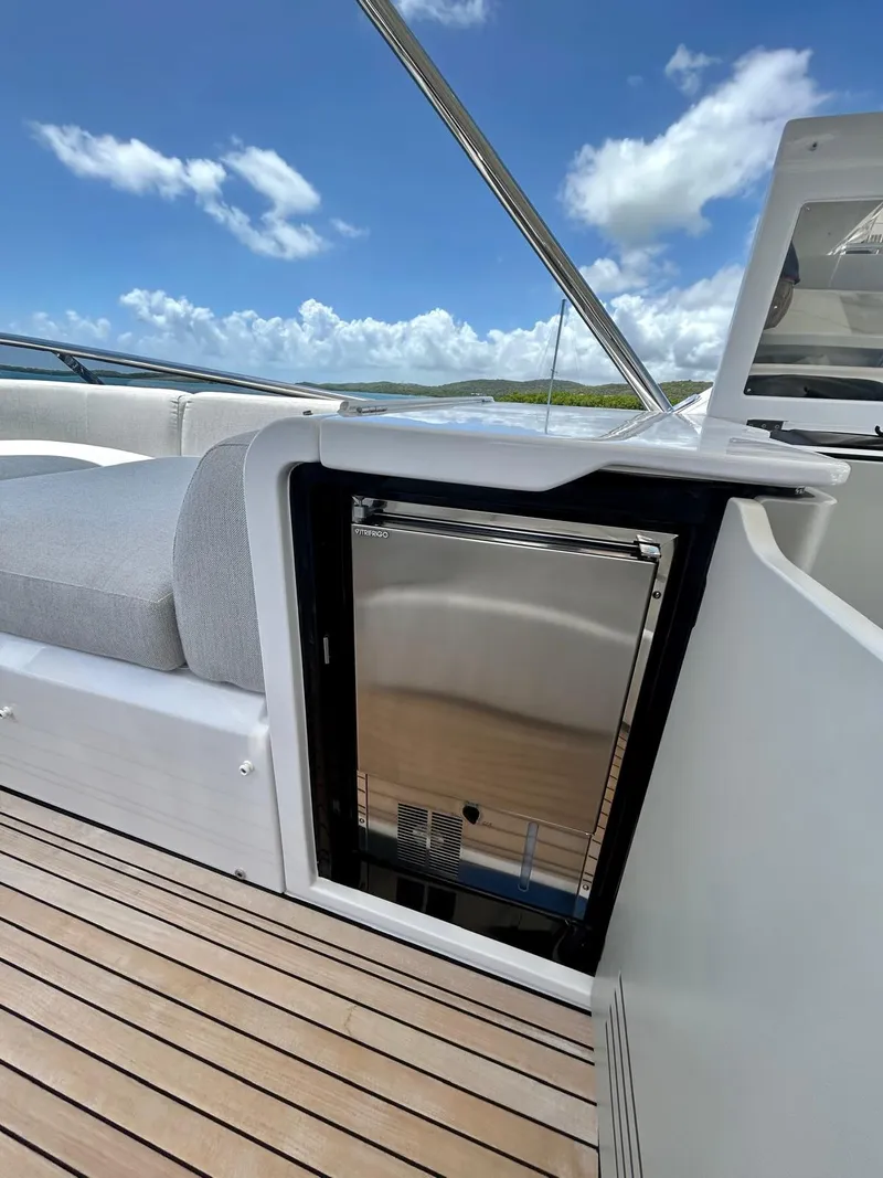 Slide: The Image of 2023 Azimut Fly 60 yacht deck with built-in mini fridge and seating. - 31