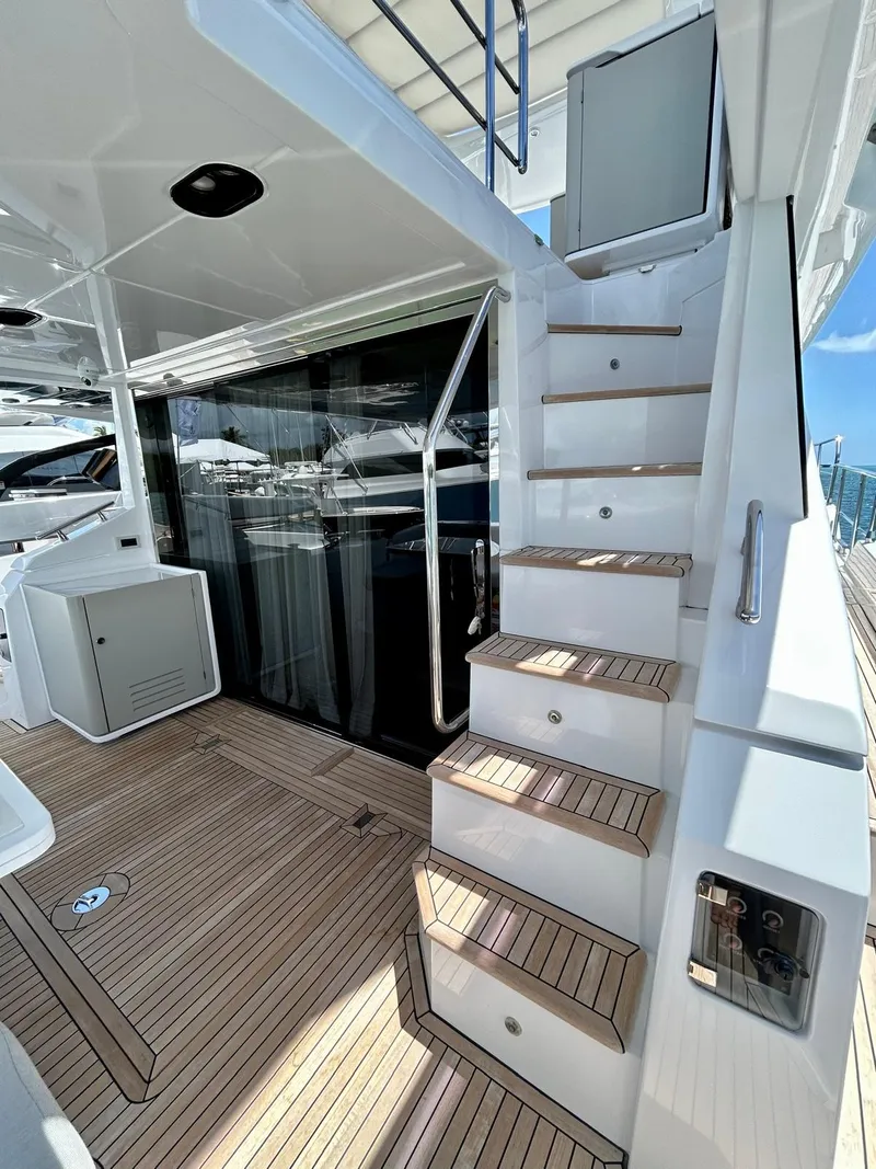 Slide: The Image of 2023 Azimut Fly 60 yacht with sleek wooden deck and modern staircase design. - 32