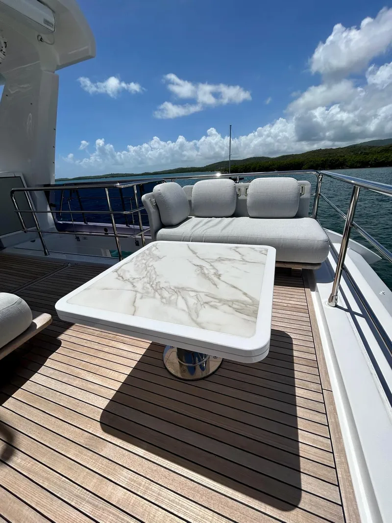 Slide: The Image of Luxury deck of 2023 Azimut Fly 60 yacht with marble table and plush seating. - 37