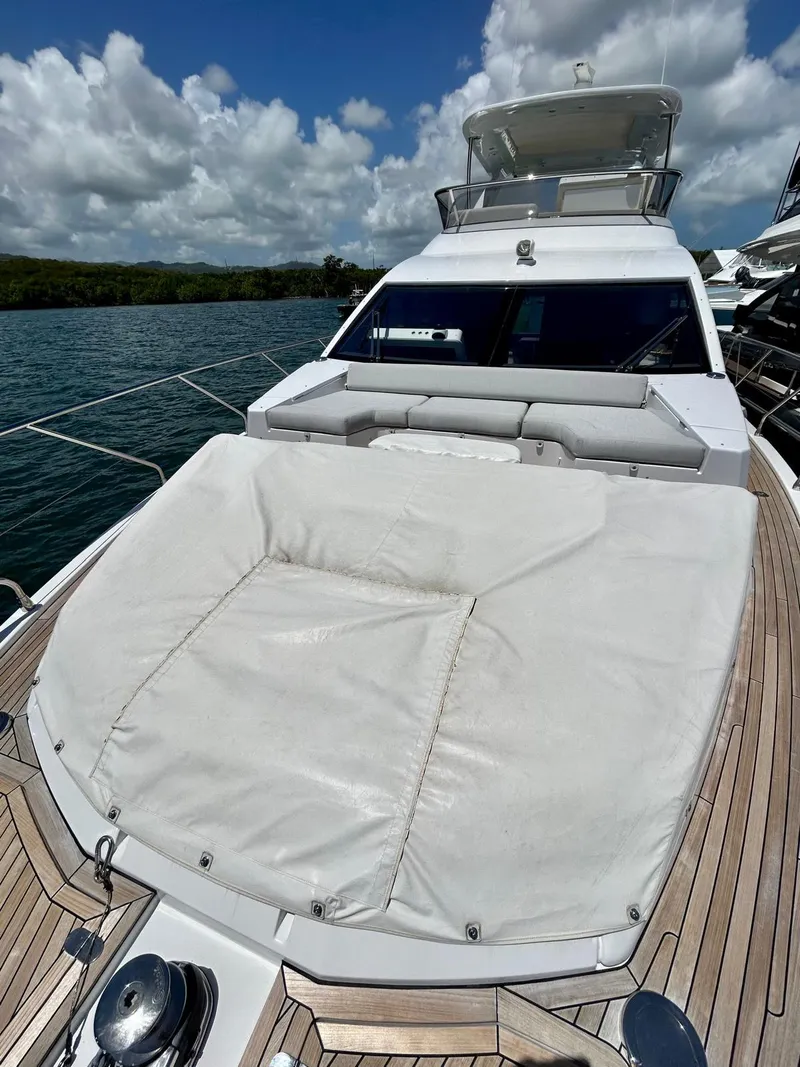 Slide: The Image of 2023 Azimut Fly 60 yacht with sun deck, docked on a sunny day. - 4