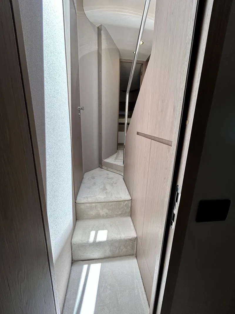 Slide: The Image of Interior hallway of 2023 Azimut Fly 60 yacht with modern design and soft lighting. - 41