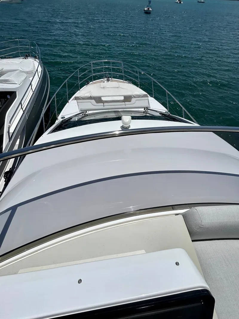 Slide: The Image of 2023 Azimut Fly 60 yacht on serene blue water, showcasing sleek design and luxury. - 42