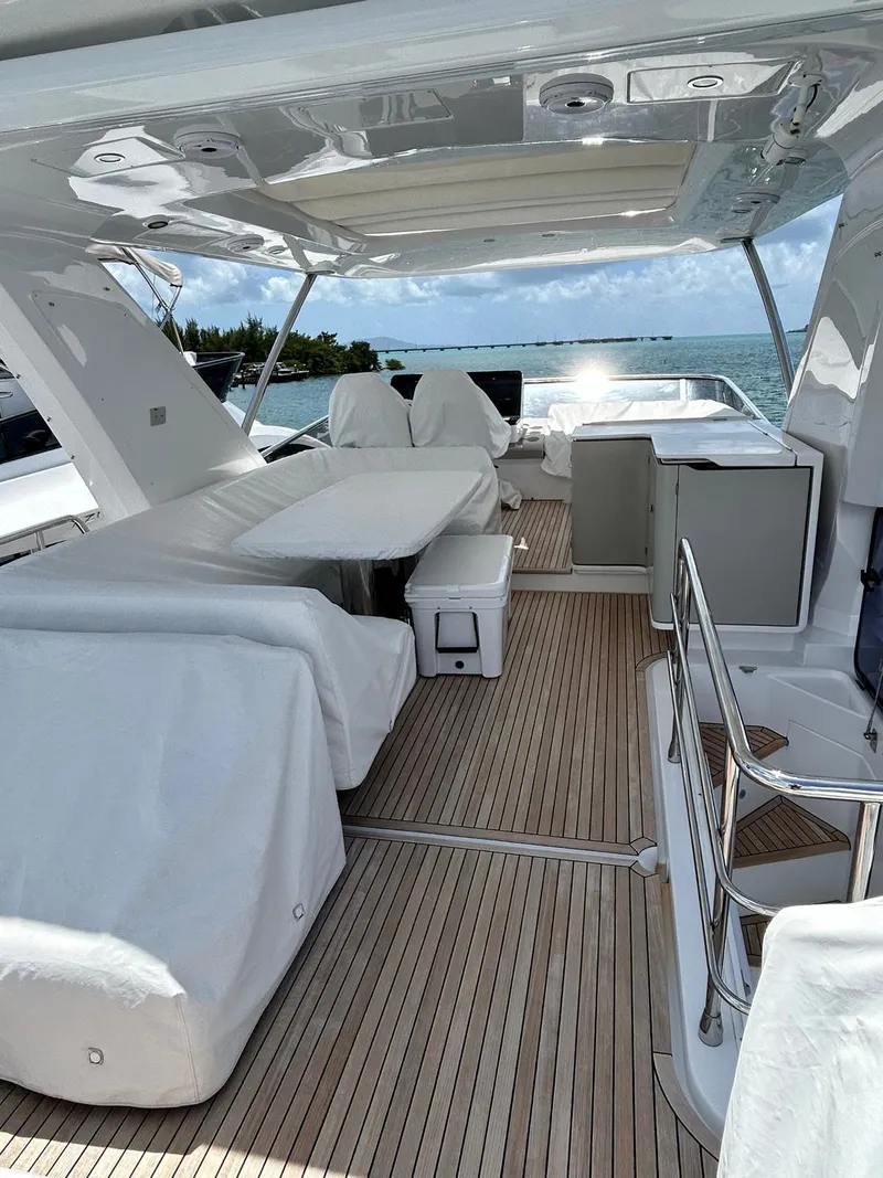 Slide: The Image of 2023 Azimut Fly 60 yacht deck with seating, table, and ocean view. - 6