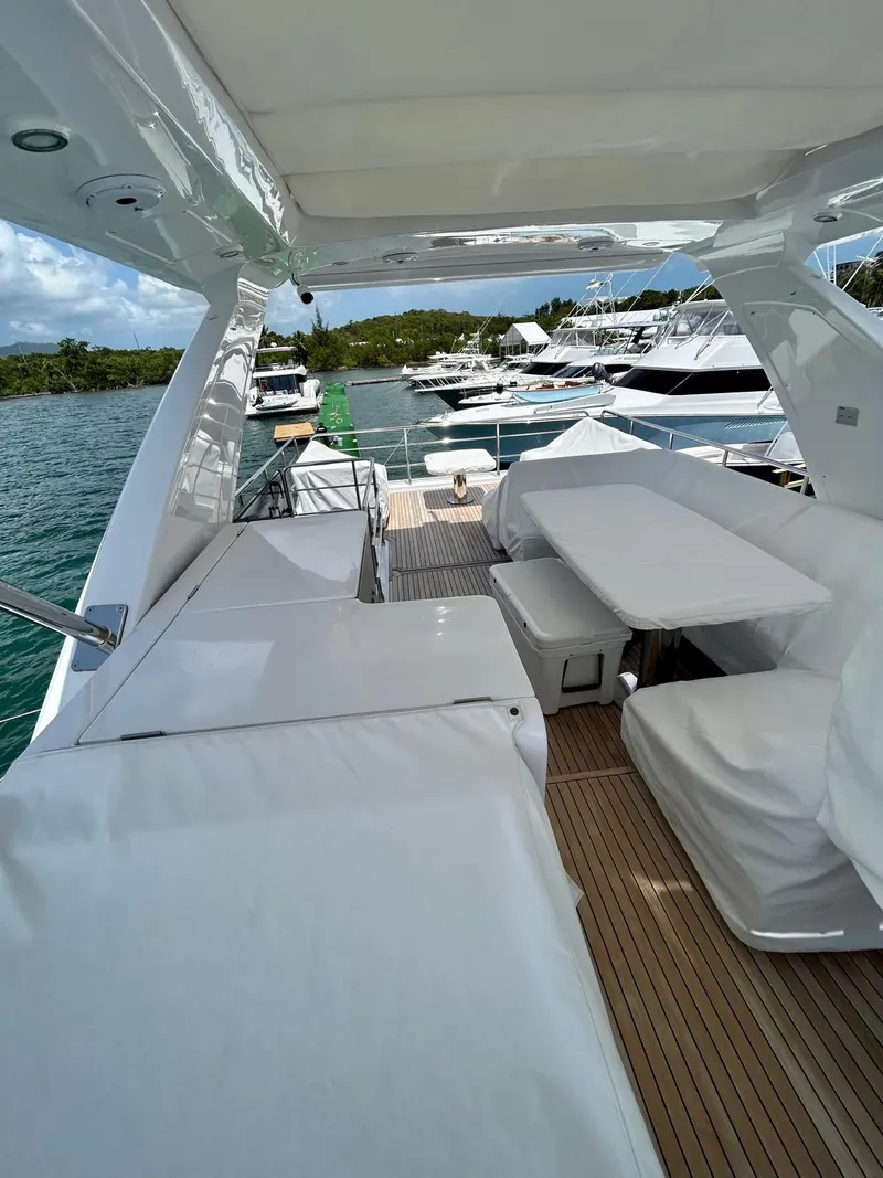 Slide: The Image of 2023 Azimut Fly 60 yacht deck with seating, docked in a marina. - 8