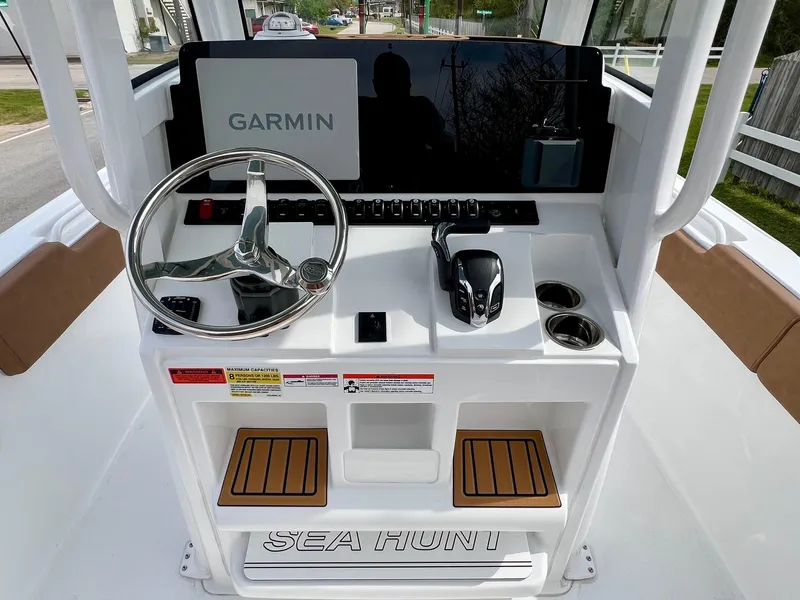 Slide: The Image of 2025 Sea Hunt Ultra 235SE boat console with Garmin navigation system and steering wheel. - 10