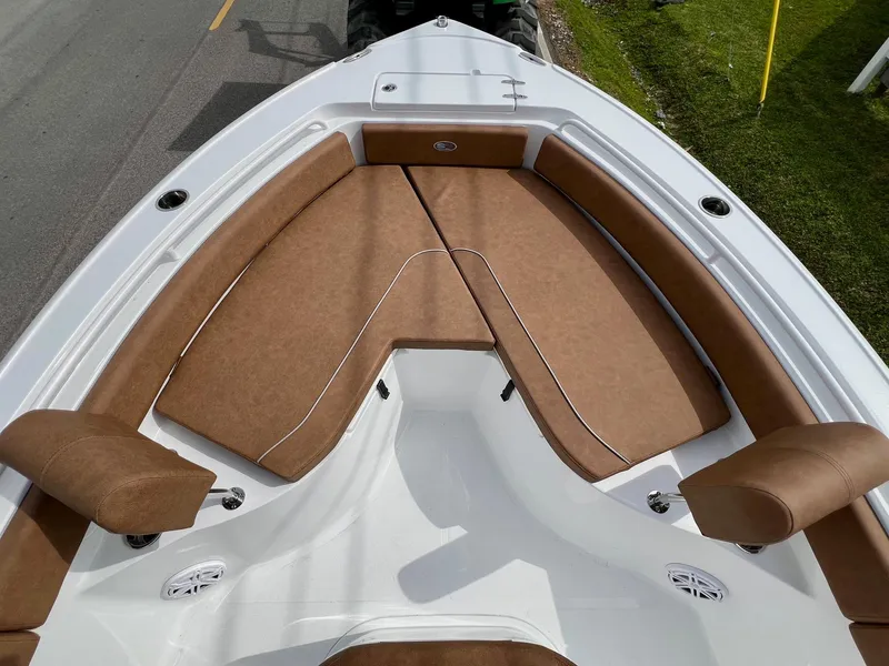 Slide: The Image of 2025 Sea Hunt Ultra 235SE boat with brown cushioned seating in the bow area. - 14