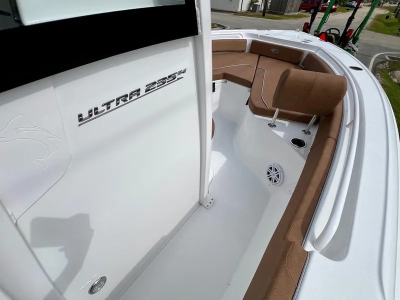 Slide: The Image of 2025 Sea Hunt Ultra 235SE boat interior with cushioned seating and sleek design. - 15
