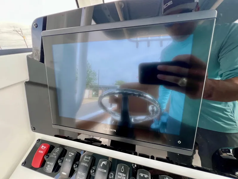 Slide: The Image of Control panel of 2025 Sea Hunt Ultra 235SE boat with Garmin display. - 17