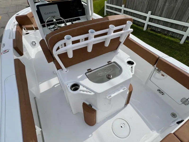 Slide: The Image of 2025 Sea Hunt Ultra 235SE boat interior with seating and fishing rod holders. - 8