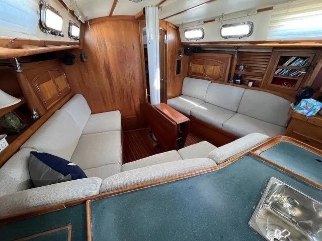 Slide: The Image of Interior of 1996 Sabre 402 sailboat with cozy seating and wooden finishes. - 11