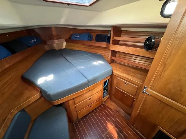 Slide: The Image of Cozy cabin interior of a 1996 Sabre 402 sailboat with wooden furnishings and a comfortable bed. - 12