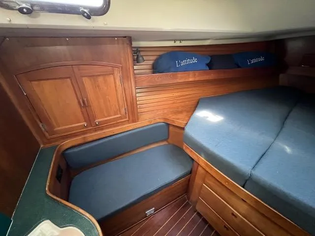 Slide: The Image of Cozy cabin interior of 1996 Sabre 402 sailboat with wooden furnishings and blue cushions. - 13