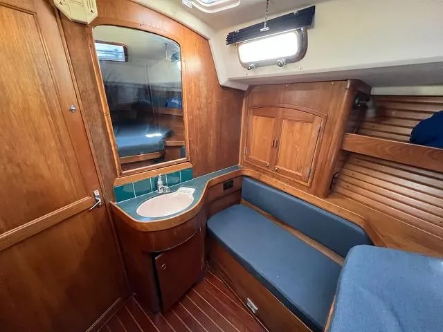 Slide: The Image of Interior of 1996 Sabre 402 yacht with wooden cabinetry and blue seating. - 14
