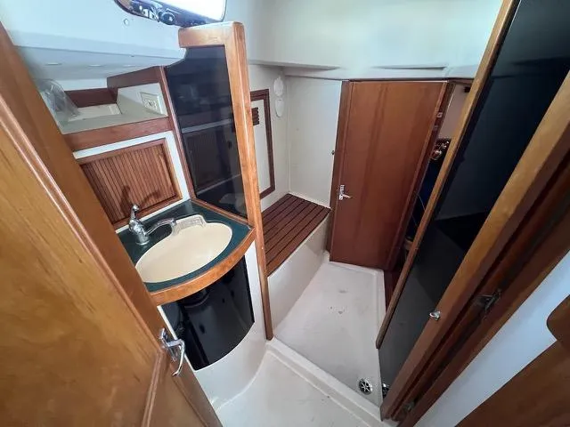 Slide: The Image of Interior of 1996 Sabre 402 yacht bathroom with sink and wooden accents. - 18