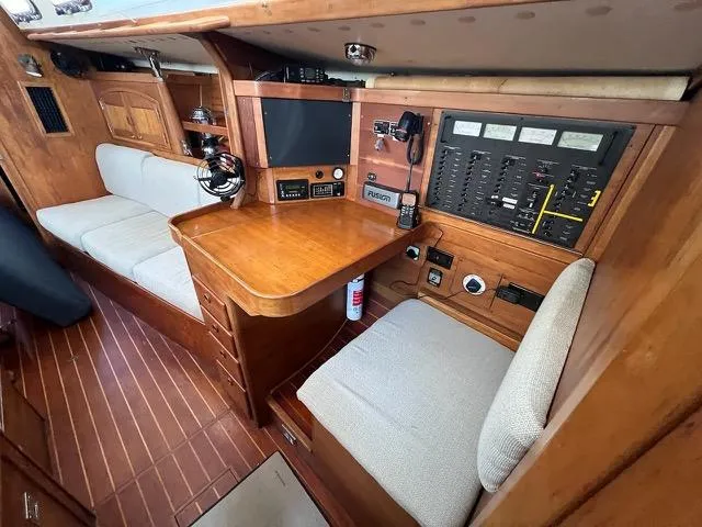 Slide: The Image of 1996 Sabre 402 yacht interior with navigation station and wooden furnishings. - 2