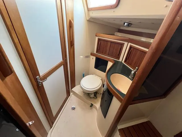 Slide: The Image of Bathroom interior of 1996 Sabre 402 yacht with wooden accents and compact design. - 20