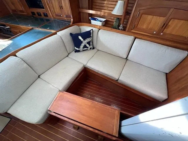 Slide: The Image of Cozy seating area in 1996 Sabre 402 yacht with nautical-themed decor. - 5