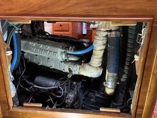 Slide: The Image of Engine compartment of a 1996 Sabre 402 boat, showcasing mechanical components and wiring. - 8