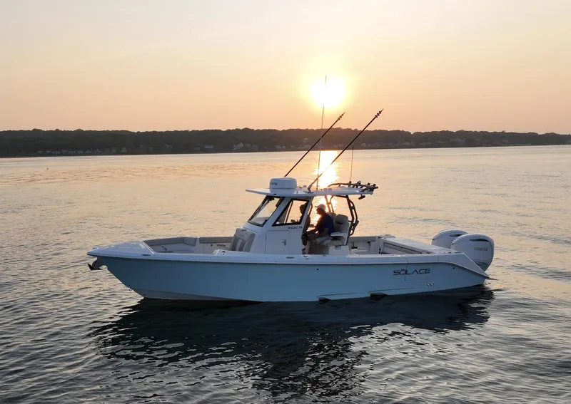 The Image of 2025 Solace 30 CS boat on calm water at sunset. - 0
