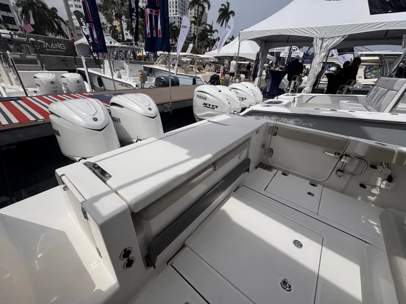 Slide: The Image of 2025 Solace 30 CS boat interior with powerful outboard engines at a boat show. - 1