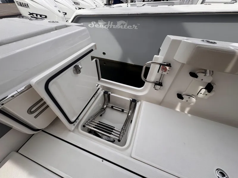 Slide: The Image of 2025 Solace 30 CS boat interior with open storage compartment and ladder. - 10