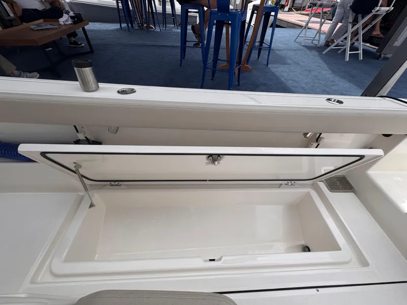 Slide: The Image of Open storage compartment on 2025 Solace 30 CS boat, showcasing spacious interior design. - 11