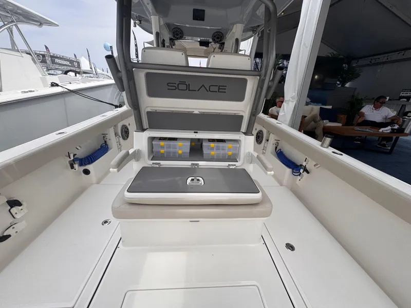 Slide: The Image of 2025 Solace 30 CS boat interior with seating and storage compartments. - 13