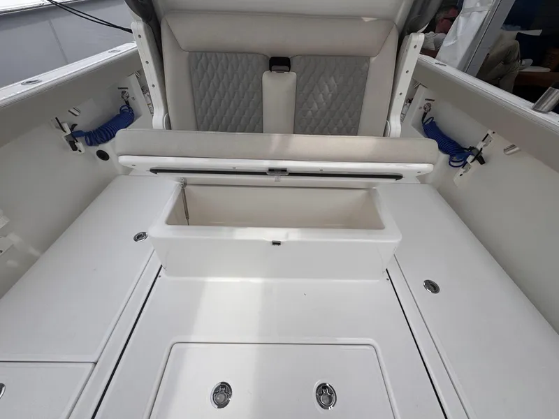 Slide: The Image of 2025 Solace 30 CS boat interior with storage compartment and cushioned seating. - 14