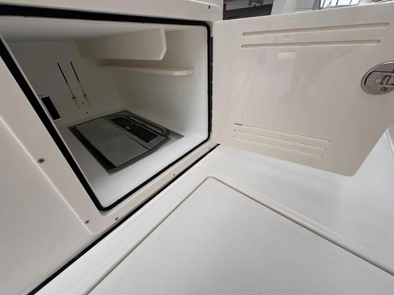 Slide: The Image of Open storage compartment on 2025 Solace 30 CS boat, showcasing interior space. - 15