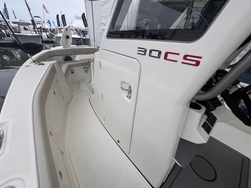 Slide: The Image of 2025 Solace 30 CS boat at a marina, showcasing sleek design and modern features. - 23