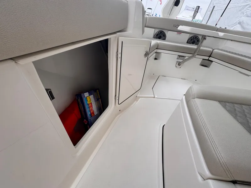Slide: The Image of Interior storage compartment of 2025 Solace 30 CS boat, featuring sleek design and seating. - 24
