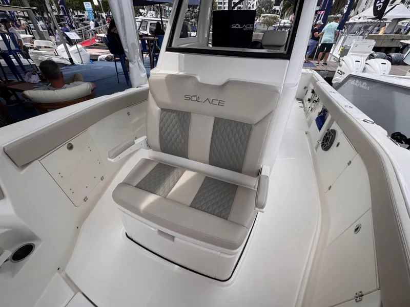 Slide: The Image of 2025 Solace 30 CS boat interior with cushioned seating and modern design. - 25