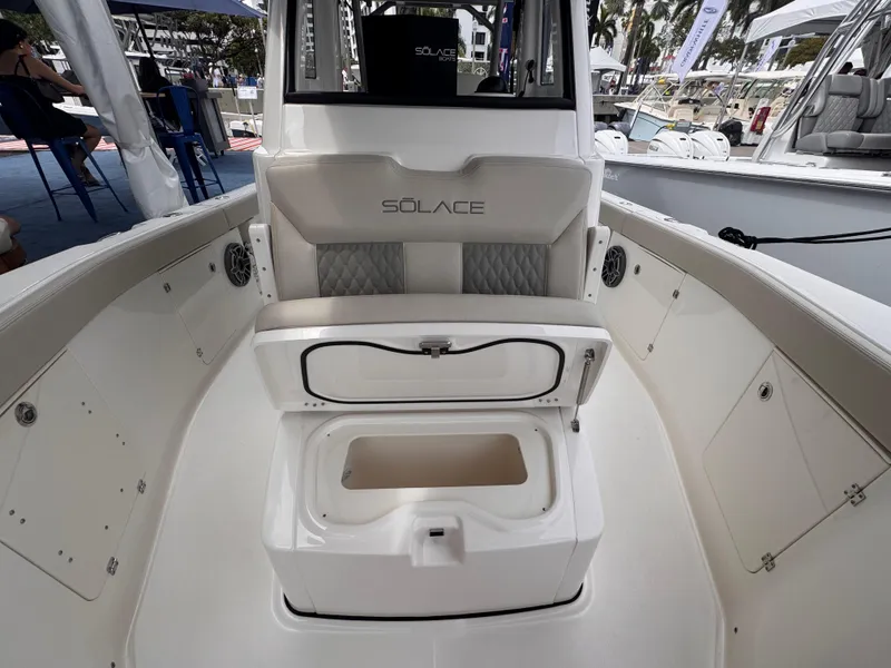 Slide: The Image of 2025 Solace 30 CS boat interior with open storage compartment and cushioned seating. - 27