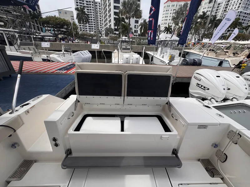 Slide: The Image of 2025 Solace 30 CS boat interior at marina, showcasing seating and storage features. - 3