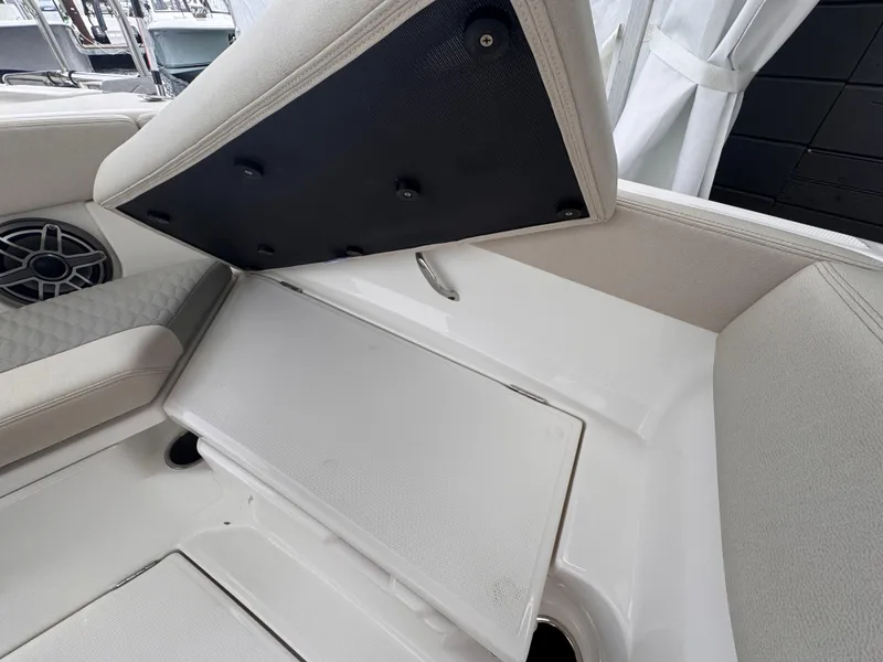 Slide: The Image of Interior seating and storage of 2025 Solace 30 CS boat, featuring sleek design and speaker system. - 31