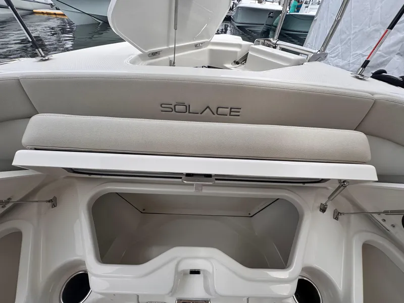 Slide: The Image of 2025 Solace 30 CS boat interior with storage compartment and cushioned seating. - 33
