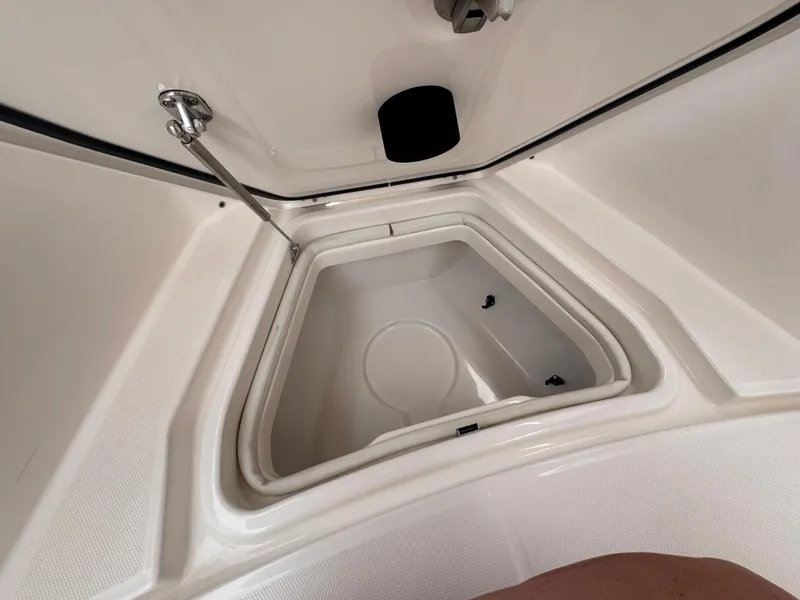 Slide: The Image of Interior storage compartment of 2025 Solace 30 CS boat, featuring a sleek, white design. - 35