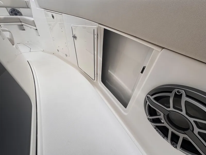 Slide: The Image of Interior view of 2025 Solace 30 CS boat, featuring storage compartment and speaker. - 36