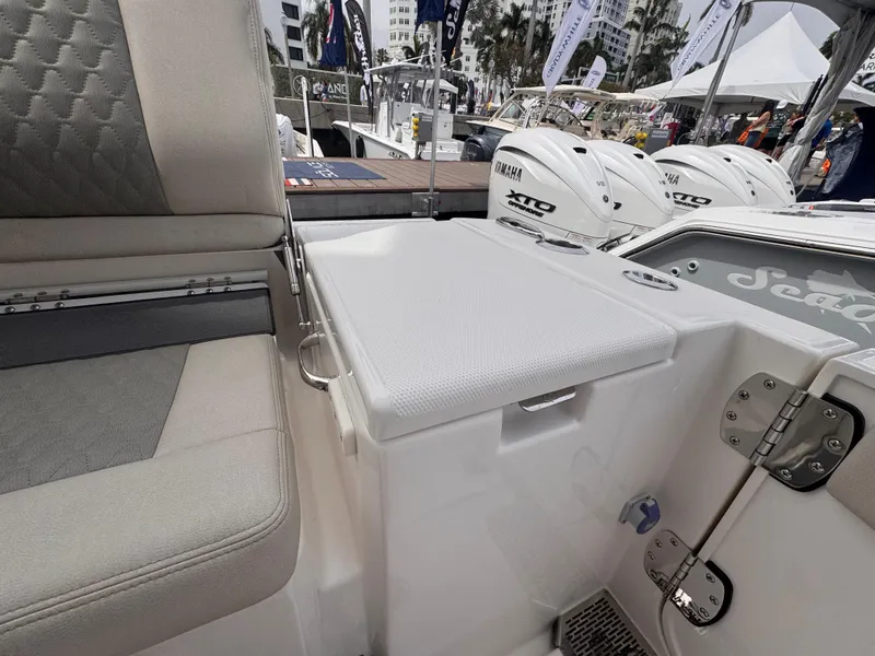 Slide: The Image of 2025 Solace 30 CS boat interior with seating and engine view at a marina. - 5