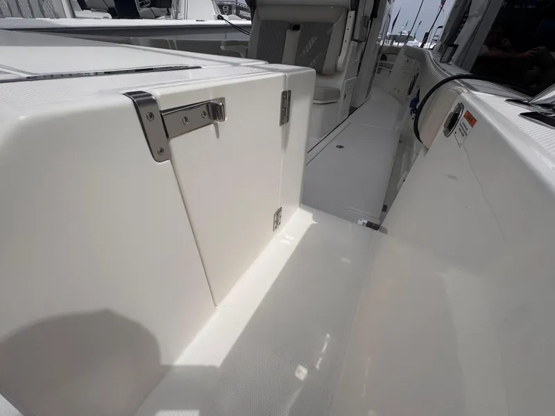 Slide: The Image of 2025 Solace 30 CS boat interior with sleek white design and stainless steel hardware. - 7