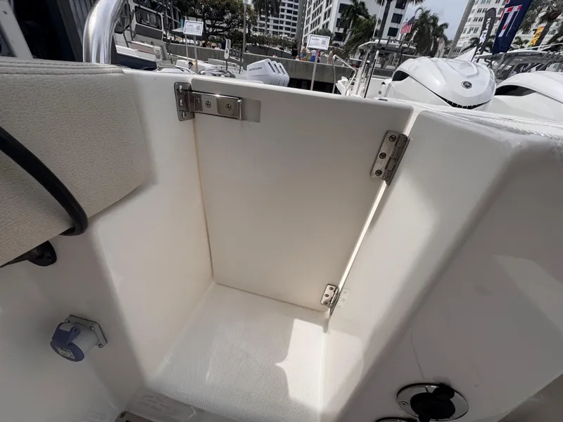 Slide: The Image of Open storage compartment on 2025 Solace 30 CS boat, showcasing interior space and hinges. - 8
