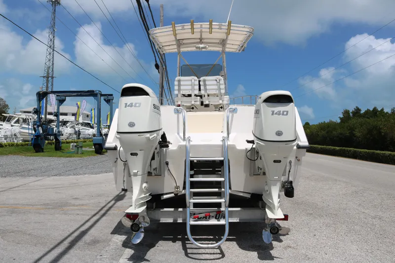 Slide: The Image of 1996 Sea Cat SL5 boat with dual 140 horsepower engines, parked on a trailer. - 4