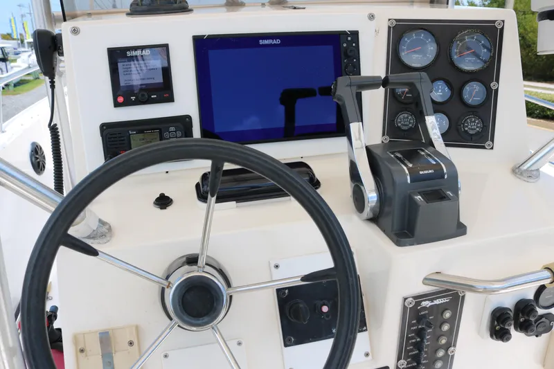 Slide: The Image of 1996 Sea Cat SL5 boat dashboard with steering wheel, gauges, and navigation equipment. - 6
