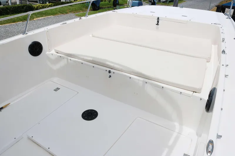 Slide: The Image of 1996 Sea Cat SL5 boat interior with white seating and storage compartments. - 8