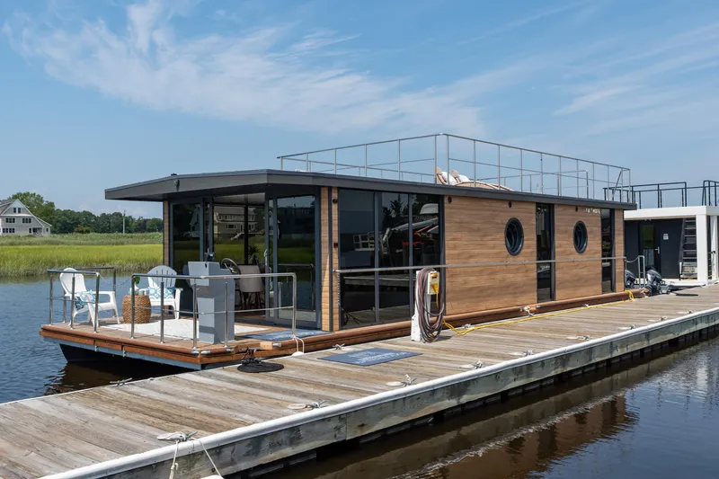 Slide: The Image of Modern Waterlodge Apart XXL houseboat docked, featuring sleek design and spacious deck, 2025 model. - 0