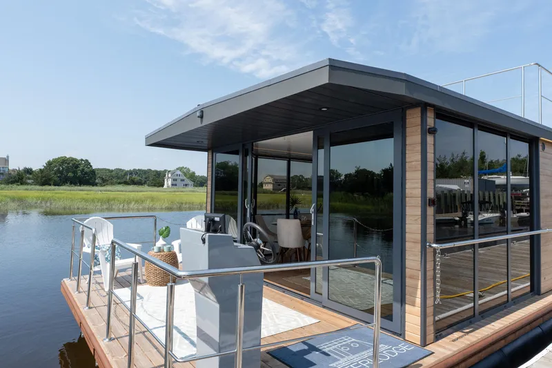Slide: The Image of Modern Waterlodge Apart XXL houseboat on a serene lake, 2025 model. - 2
