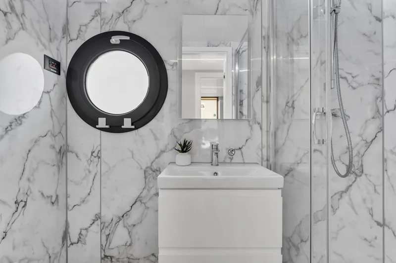 Slide: The Image of Modern bathroom in Waterlodge Apart XXL 2025, featuring marble walls and sleek fixtures. - 21