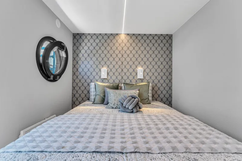 Slide: The Image of Modern bedroom in Waterlodge Apart XXL 2025 with stylish decor and porthole window. - 26